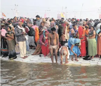  ?? | AP African News Agency (ANA) ?? HINDU devotees take spiritual cleansing dips at the Sangam, the confluence of the rivers Ganges, Yamuna and the mythical Saraswati, during the Kumbh Mela festival in Prayagraj, India, yesterday.