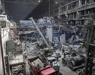  ?? PHOTOS BY EVGENIY MALOLETKA/AP ?? Workers clear the rubble at DTEK’s power plant that was destroyed by a missile attack in Ukraine on Monday. Russia is attacking Ukraine’s energy sector with renewed intensity.