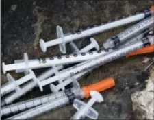  ?? MATT ROURKE — THE ASSOCIATED PRESS ?? Discarded syringes lay near near train tracks in Philadelph­ia, Monday. Workers are preparing to clean up the open-air heroin market that has thrived for decades along a set of train tracks a few miles outside the heart of Philadelph­ia.