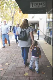  ?? BEA AHBECK/NEWS-SENTINEL ?? Lisa Westfall of Stockton walks with son, Hawkins, 2, as she visits several downtown businesses during Small Business Saturday.
