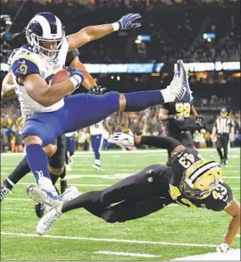  ?? Wally Skalij Los Angeles Times ?? MALCOLM BROWN scores past Saints safety Marcus Williams on an 18-yard pass from Jared Goff to cut the Rams’ deficit to 35-24 in the third quarter.