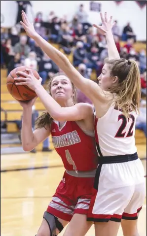  ?? Staff photo/David Pence ?? New Knoxville’s Avery Henschen looks to go up for a basket with Fort Loramie’s Kenize Hoelscher (22) during a non-conference girls basketball game on Tuesday at Fort Loramie High School.