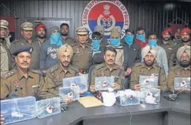  ?? PARDEEP PANDIT/HT ?? ■ Police officials displaying the arms and ammunition seized in Jalandhar on Monday.