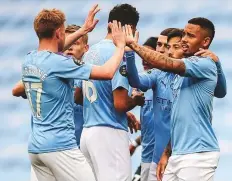  ?? AP ?? Manchester City players celebrate after scoring the opening
■ goal during the Premier League clash against Newcastle at the Etihad Stadium yesterday. The hosts won 5-0.