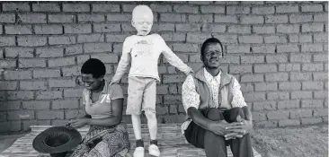  ??  ?? TARGETED: Edna Cedric, left, Harrison, 9, and Marizane Kapiri in Machinga, southern Malawi. The family was attacked in February 2016. Harrison’s twin brother, Hari, was abducted and murdered.