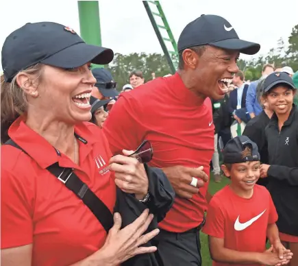  ?? ROB SCHUMACHER/USA TODAY SPORTS ?? Tiger Woods enjoys his Masters victory with son Charlie and daughter Sam, right.