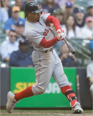  ?? (Photo by Morry Gash, AP) ?? Boston Red Sox’s Mookie Betts hits a three-run home run during the ninth inning of Thursday’s game against the Milwaukee Brewers.