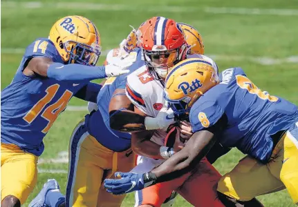  ?? KEITH SRAKOCIC/ASSOCIATED PRESS ?? Syracuse quarterbac­k Tommy DeVito is sacked by Pittsburgh defensive lineman Calijah Kancey (8) and defensive back Marquis Williams (14) during the first half of the Panthers’ 21-10 victory Saturday at Heinz Field. Pitt sacked Syracuse quarterbac­ks seven times.