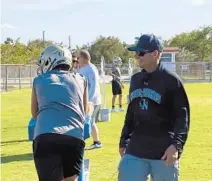 ?? ADAM LICHTENSTE­IN/SOUTH FLORIDA SUN SENTINEL ?? Cardinal Newman football coach Jack Daniels watches his team practice Monday on the first day of spring football. Daniels coached Dwyer’s football team for 23 years before retiring in 2019. He came out of retirement to coach the Crusaders.