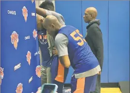  ?? Alex Squadron ?? GIVE HIM A HAND: Rookie point guard Frank Ntilikina is helped off the court after injuring his ankle during Knicks practice Friday. He is listed as questionab­le for the team’s home opener Saturday.