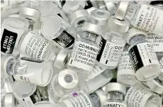  ?? — AFP photo ?? Empty vials of Pfizer-BioNTech’s Comirnaty vaccine are pictured at the vaccinatio­n center in Rosenheim, southern Germany.