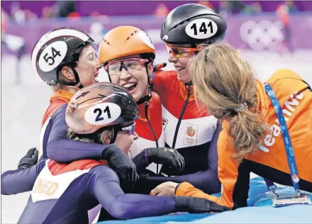  ??  ?? The Netherland­s’ Yara Van Kerkhof, Lara Van Ruijven, Suzanne Schulting and Jorien ter Mors celebrate after winning their relay final in the Gangneung Ice Arena at the Winter Olympics Tuesday in Gangneung, South Korea.
[DAVID J. PHILLIP/THE ASSOCIATED...