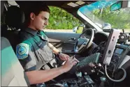  ?? TIM MARTIN/THE DAY ?? Patrol officer Evan Grasser of the Town of Groton Police Department responds to a motor vehicle complaint on July 17 near the Fort Hill Pharmacy parking lot.