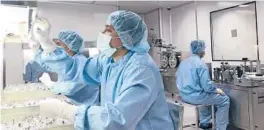  ?? AL-EMRUN GARJON/AP ?? Production personnel perform an inspection of filled vaccine vials inside the Incepta plant Feb. 13 in Bangladesh. It is one of three factories that the AP found whose owners say they could produce the COVID-19 vaccine, if permitted.