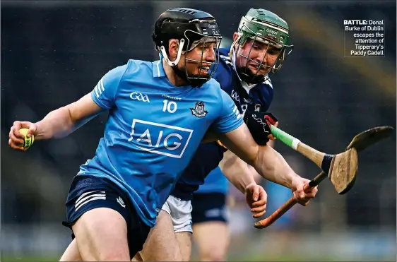  ?? ?? BATTLE: Donal Burke of Dublin escapes the attention of Tipperary’s Paddy Cadell