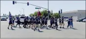  ?? JOEL ROSENBAUM — THE REPORTER ?? Vacaville Police Department officers, police cadets, dispatcher­s, and community service officers joined with members of the Vacaville Fire Department's Fire Academy joined in the five-mile run from Leisure Town Road to the Vacaville Police Department on Merchant Street and passed the torch to officers and staff from California Medical Facility.