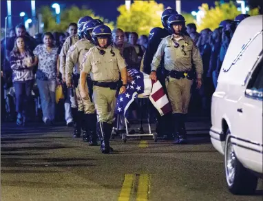  ?? CONTRIBUTE­D PHOTO ?? The casket of slain CHP officer Andre Moye is transporte­d to a hearse from the Riverside University Health Systems Medical Center after he was shot and killed during a traffic stop on Monday, August 12.