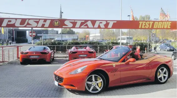  ??  ?? A client drives a Ferrari car out of the Push-Start test-drive service, in Maranello, Italy, just outside the gates of the Ferrari Museum.