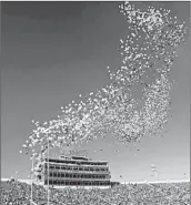  ?? AJ MAST/AP 2017 ?? Some colleges are ending the tradition of releasing balloons into the air before football games.