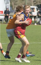  ?? Photograph­s by AMANDA EMARY. ?? Right: Dusties fourths player Cody Templeton is tackled by his Korumburra-Bena opponent. The Dusties went on to lose the semi final by five points, eliminatin­g them from the finals series.