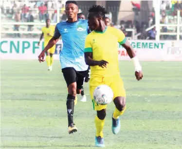  ??  ?? Reigning Highest Goal scorer in the NPFL and Kano Pillars striker, Junior Lokosa shields the ball from Victor Okoro of Nasarawa United during their match in the 2018 NPFL season.