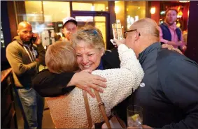  ?? NWA Democrat-Gazette/ANDY SHUPE ?? Denise Garner, winner of State House District 84, gets a hug Tuesday as she enters the room during a watch party for the Washington County Democratic Party of Arkansas at Farrell’s Lounge in Fayettevil­le.