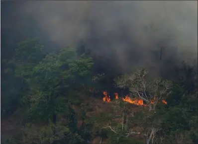  ?? AP/VICTOR R. CAIVANO ?? Wildfires consume an area of rain forest near Porto Velho in Brazil on Friday.