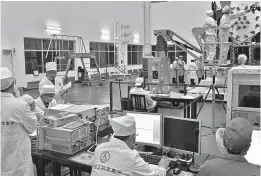  ??  ?? Left: Engineers make further testing before launching a new Beidou satellite.