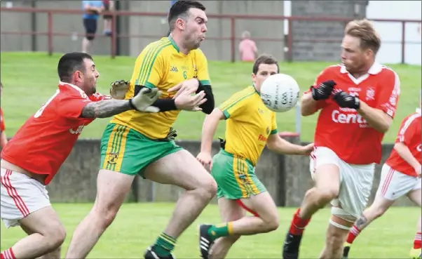  ??  ?? Stabannon’s Niall Cluskey braces himself for a challenge from St Nicholas’ Jason Maguire during their JFC clash at the Gaelic Grounds on Friday night.