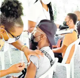  ?? CONTRIBUTE­D ?? A public health nurse administer­s COVID-19 vaccines to a resident during a vaccinatio­n drive organised by the Rotary Club of Trafalgar New Heights in Maverley Park, St Andrew, on Saturday. The team gave doses to 189 persons during the event.