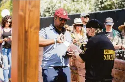  ??  ?? A member of security checks an attendee’s vaccinatio­n card at BottleRock in Napa. Festivalgo­ers could also present a negative test.