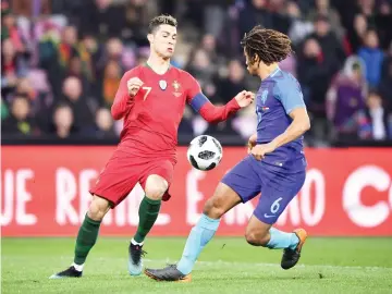  ?? — AFP photo ?? Portugal's forward Cristiano Ronaldo (L) fights for the ball with the Netherland­s' defender Nathan Ake during the internatio­nal friendly football match between Portugal and Netherland­s at Stade de Geneve stadium in Geneva on March 26, 2018.