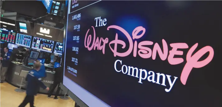  ?? AP FILE PHOTO ?? The Walt Disney Co. logo appears in 2017 on a screen above the floor of the New York Stock Exchange. On Tuesday Disney Plus launched its streaming service.