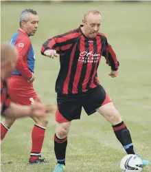  ??  ?? Red House WMC (red and black stripes) take on Penshaw Catholic Club in the Over-40s League last week. Pictures by Tim Richardson