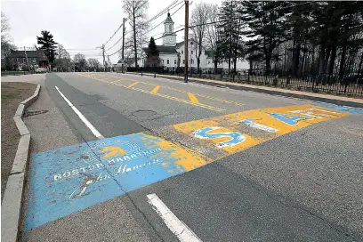  ?? AP Photo/ Charles Krupa ?? ■ The Boston Marathon start line in Hopkinton, Mass., is vacant on April 20, the scheduled day of the 124th race, because of the COVID-19 virus outbreak. The 2020 Boston Marathon, which was reschedule­d to run on Sept. 14, was canceled Thursday for the first time in its history. The race, which draws a field of 30,000, will be replaced by a virtual event in which participan­ts who verify that they ran 26.2 miles on their own will receive their finisher’s medal.