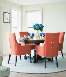  ?? JARED KUZIA ?? “The orange dining chairs in this airy waterfront dining room are from Kravet,” says Jillian Hayward Schaible, who adds it’s worth investing in pieces you sit, sleep and eat on.
