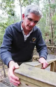  ??  ?? Ranger-in-charge Brendan Moodie examines a major upgrade – replacing 6000 corroded bolts on the Lady Barron Falls Circuit.