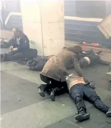  ?? THE ASSOCIATED PRESS ?? Blast victims lie near a subway train hit by an explosion at the Technologi­cal Institute subway station in St.Petersburg, Russia, on Monday. At least 10 people were killed, and dozens wounded in the bombing.