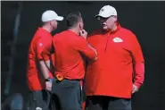  ?? BRYNN ANDERSON — THE ASSOCIATED PRESS ?? Kansas City Chiefs head coach Andy Reid, right, talks with others on the football field during practice on Thursday in Davie, Fla., for the NFL Super Bowl 54 football game.