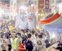  ??  ?? A ‘dragon’ being paraded at Carpenter Street during the Kuching Inter-Cultural Mooncake Festival on Monday.