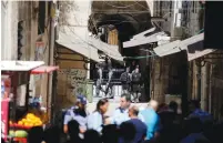  ?? (Ammar Awad/Reuters) ?? POLICE BLOCK a road following yesterday’s terrorist attack in the capital’s Old City.