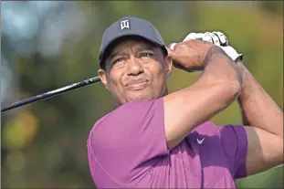  ?? AP - Phelan M. Ebenhack, file ?? Tiger Woods watches a tee shot during the first round of the PNC Championsh­ip in December.