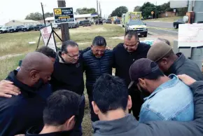  ?? COURTNEY SACCO/CALLER-TIMES-USA TODAY NETWORK ?? Pastors from San Antonio pray Wednesday near the scene of the church shooting in Sutherland Springs, Texas.