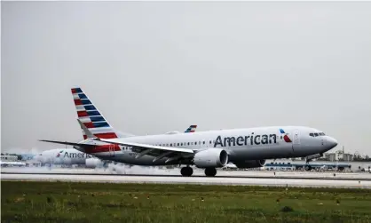  ?? Photograph: Chandan Khanna/AFP/Getty Images ?? An American Airlines plane lands in Miami. A Guatemalan man survived a 2½-hour flight stowed away in the landing gear compartmen­t of an AA jet on Saturday.