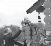  ?? XINHUA ?? Visitors from Britain hang red lanterns at residentia­l quarters in Zhangjiaji­e city, Hunan province.