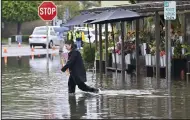  ?? (AP/The Orange County Register/Jeff Gritchen) ?? Mandy Garrett walks across Marina Drive as she leaves Devynn’s Garden, just south of Pacific Coast Highway, on Thursday in Seal Beach, Calif.