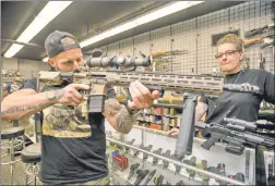  ??  ?? ARMED: Owner Irene Vignola (right) shows customer Christophe­r Giannetti weapons at Rockland Indoor Shooting and Education in Pearl River. Gun sales are burgeoning across the country.