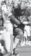  ?? STAFF PHOTO BY ROBIN RUDD ?? Tennessee running back Jalen Hurd is hit in the backfield for a loss by Florida’s Caleb Brantley during Saturday’s game at Neyland Stadium. Hurd hasn’t always had plenty of room to run during the first four games of this season, but he often has found...