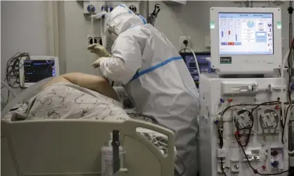  ?? Photograph: Vitali Timkiv/AP ?? A doctor treats a patient with coronaviru­s at a hospital in south Russia. The highest decline in life expectancy in years was in Russia.