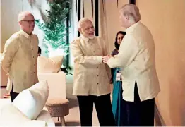  ?? — PTI ?? Prime Minister Narendra Modi shakes hands with US President Donald Trump before the pre-Asean summit gala dinner in Manila on Sunday.